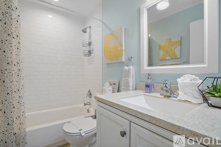 A bathroom with a white toilet, a white sink, and a white bathtub.