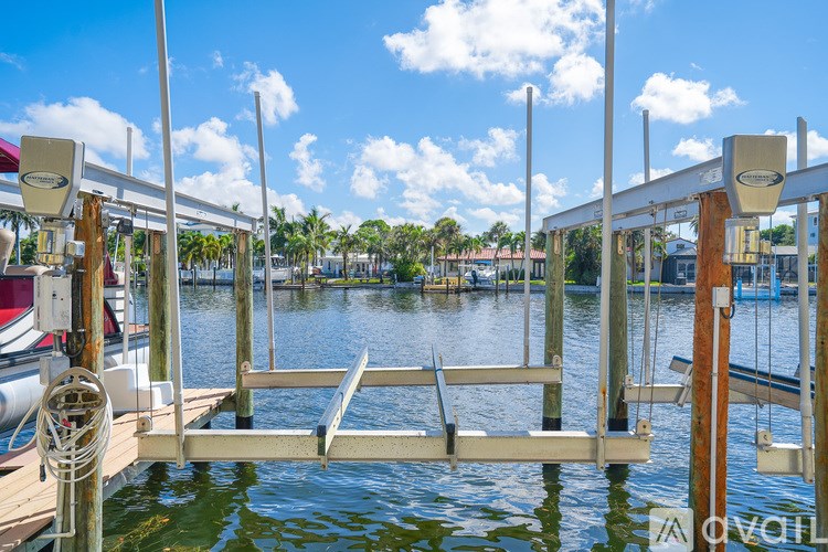 A dock with a boat tied to it and a sign that says "Avail" on the side.