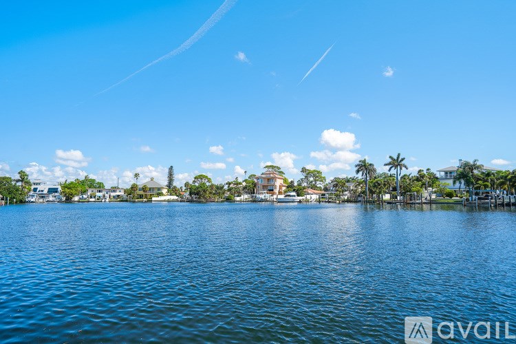 A body of water with a clear blue sky and a few clouds.