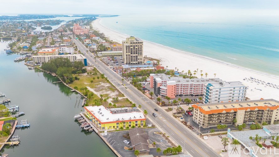 A beachfront city with a long stretch of beach and a body of water.
