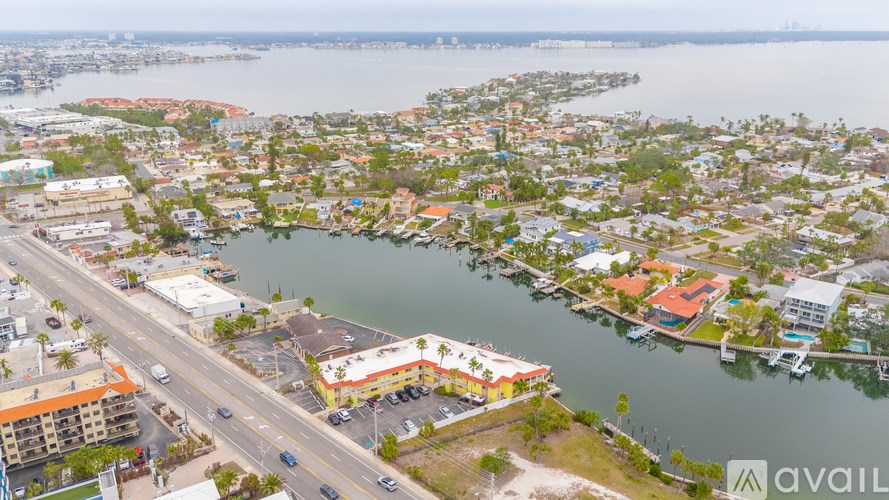 A bird's eye view of a city with a large body of water in the foreground.