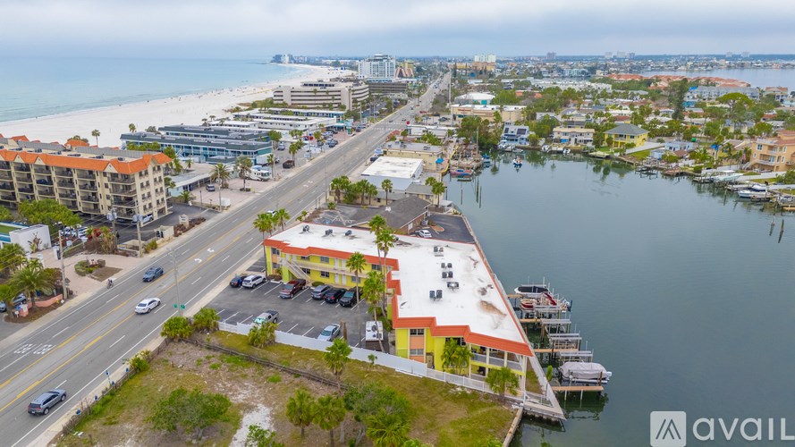 A view of a city with a body of water and a road with cars.