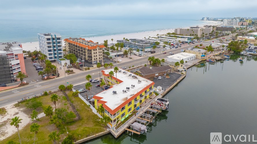 A colorful building sits on the edge of a body of water.