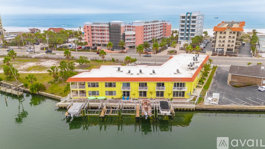 A yellow building is in the foreground of a waterfront scene.