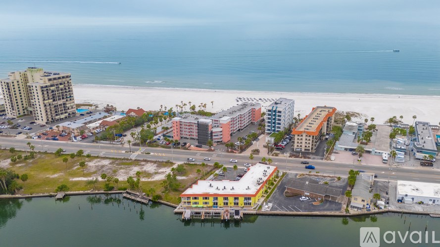 A view of a beachfront area with buildings and a body of water.
