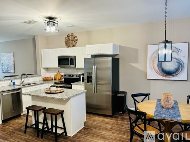 A modern kitchen with a dining table and chairs.