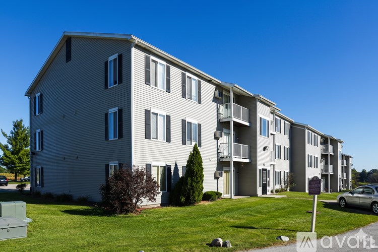 A black and white logo for MRD Apartments with a building silhouette above the text.