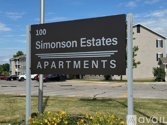 A row of modern apartment buildings with green lawns in front.