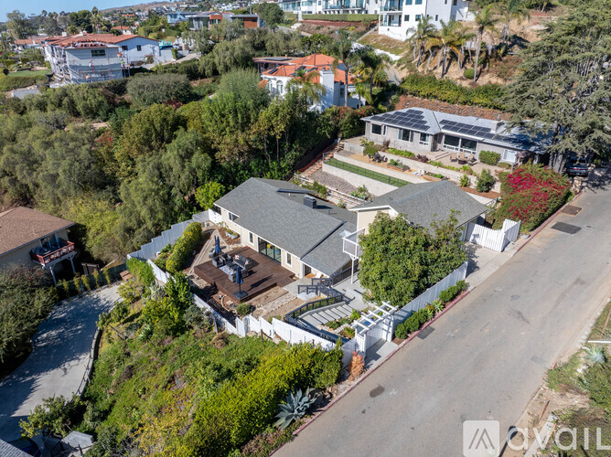 A bird's eye view of a residential area with houses and trees.