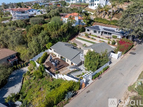 A bird's eye view of a residential area with houses and trees.