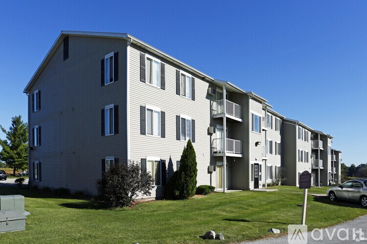 Apartment building with a sign that says "available" in front of it.