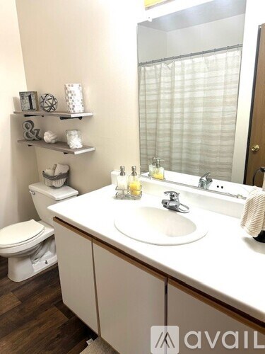 A bathroom with a white sink and toilet.