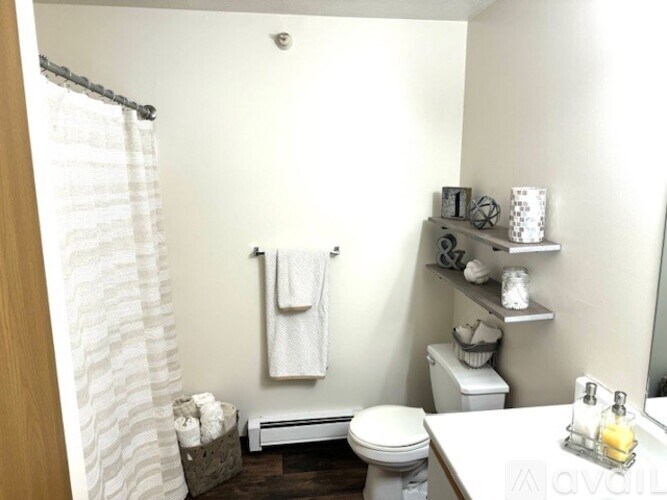 A white towel is hanging on a towel rack in a bathroom.