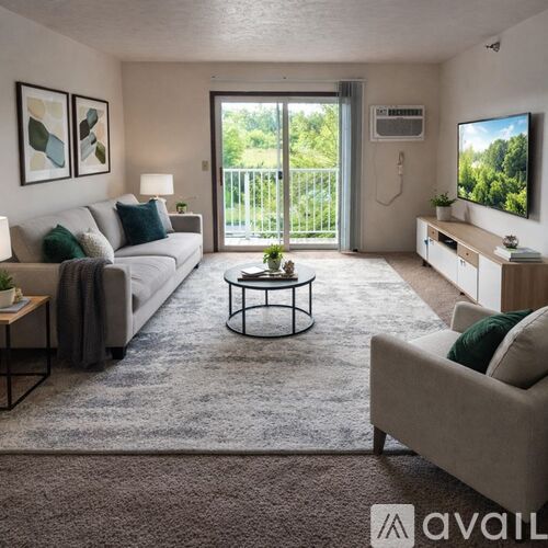 A living room with a brown couch and a television on the wall.