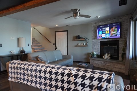 A living room with a couch and a television.