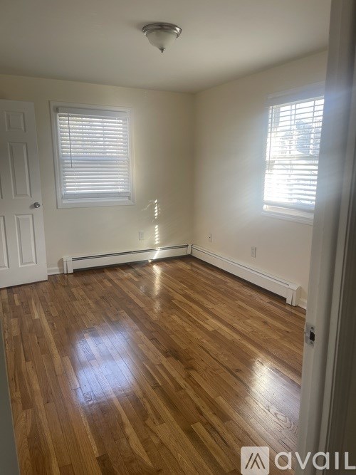 A room with wooden floors and white walls.