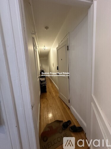 A hallway with a mat on the floor that says "Welcome".
