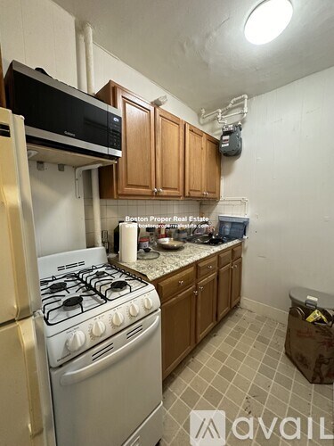A kitchen with a stove, oven, and cabinets.