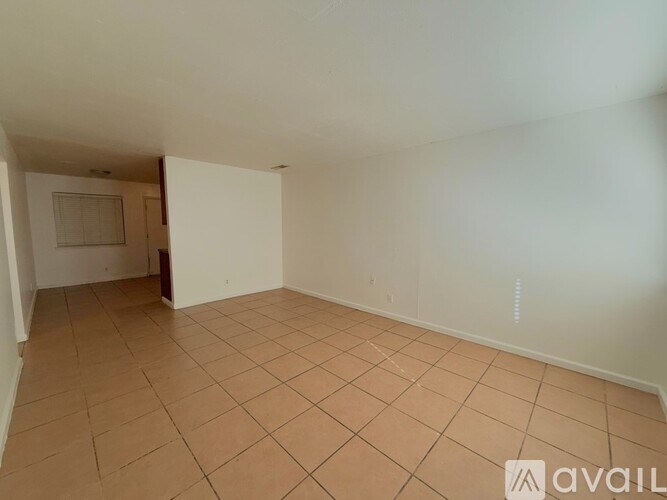 A room with tiled flooring and white walls is available for rent.