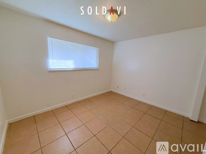 A room with a window and tiled floor is for sale.