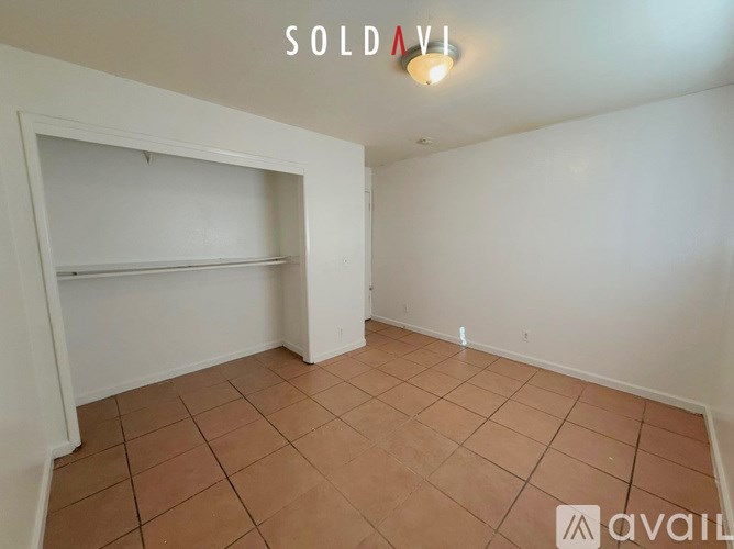 A room with a white wall and a tiled floor is marked as sold.