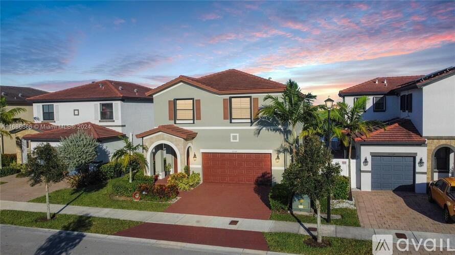 A house with a red tiled roof and a garage door is for sale.