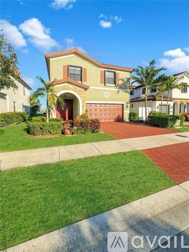 A house with a red door and a driveway in front.