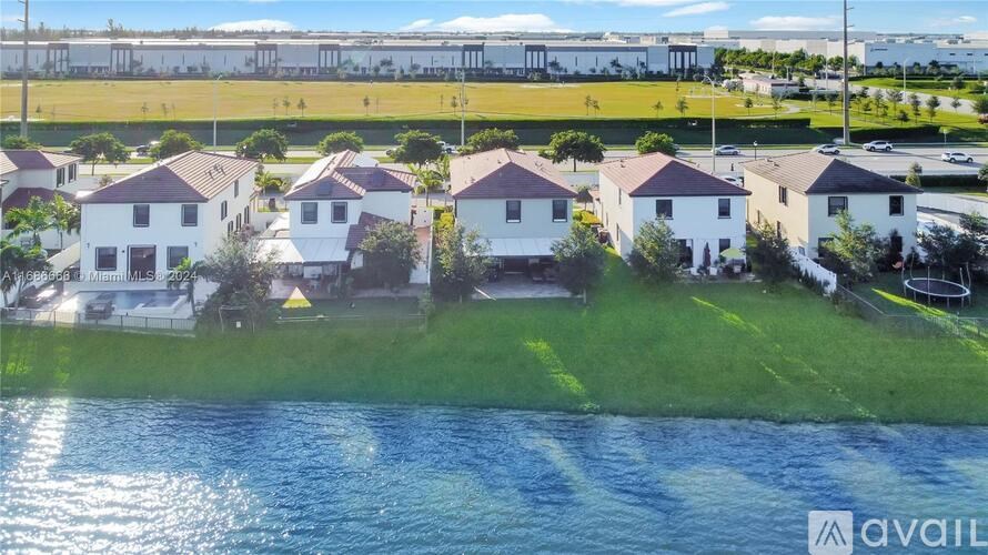 A row of houses with a body of water in front.