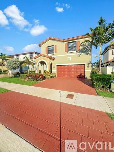 A house with a red driveway in front of it.