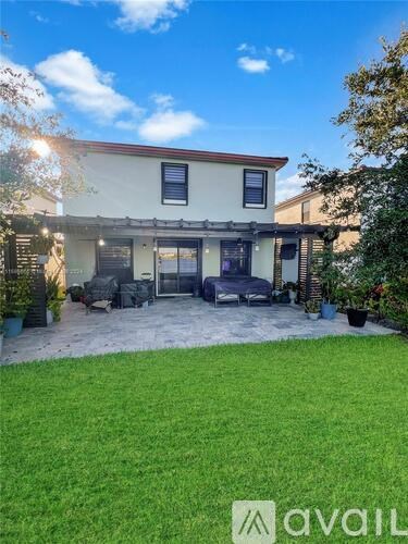 A house with a patio and a lawn in front.