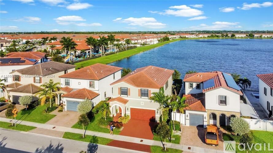 A row of houses with a body of water in front of them.