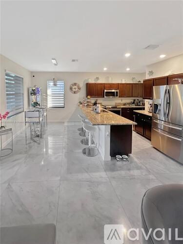 A kitchen with a marble floor and modern appliances.