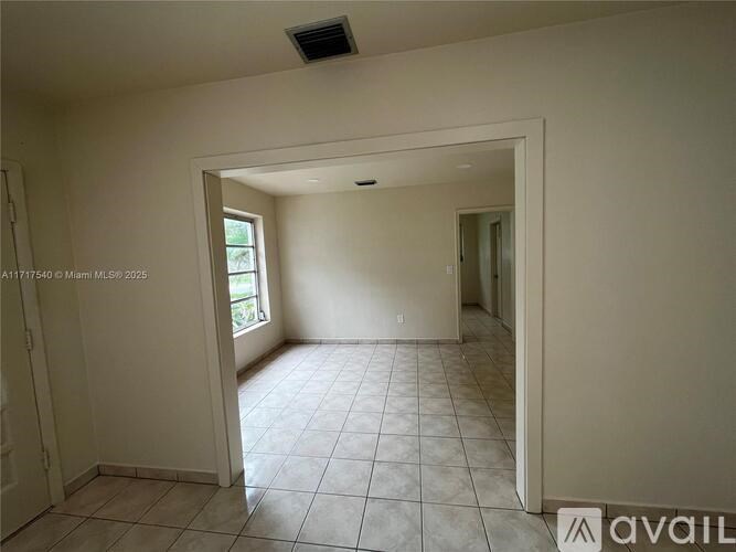 A room with tiled flooring and a window is available for rent.