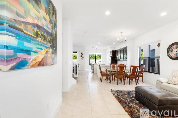 A large painting hangs on the wall in a spacious living room.