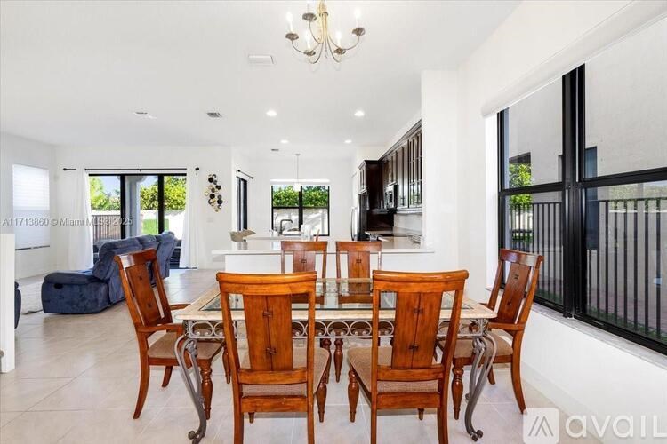 A dining room with a table set for six.