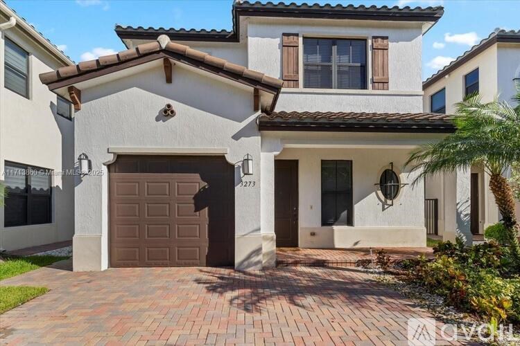 A house with a brown garage door is for sale.