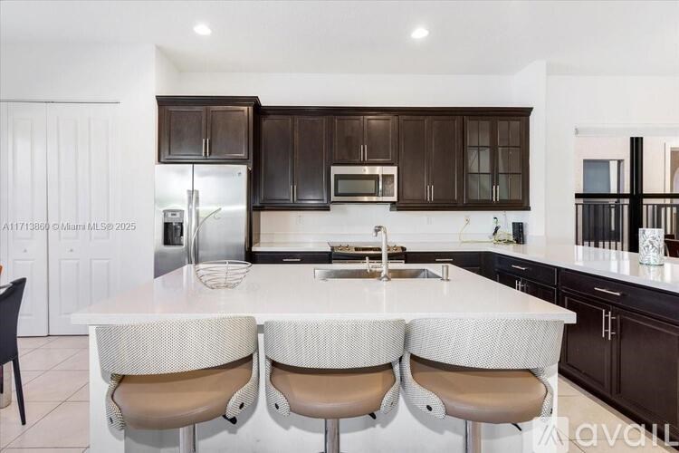 A kitchen with brown cabinets and white countertops.