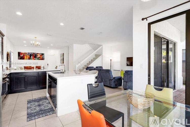 A modern kitchen with a dining table and chairs.