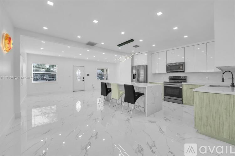 A modern kitchen with a marble floor and white walls.