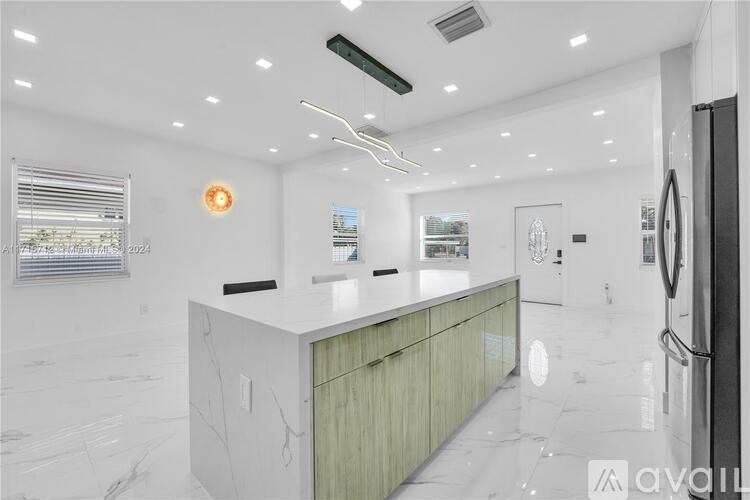 A modern kitchen with a white marble floor and a central island.