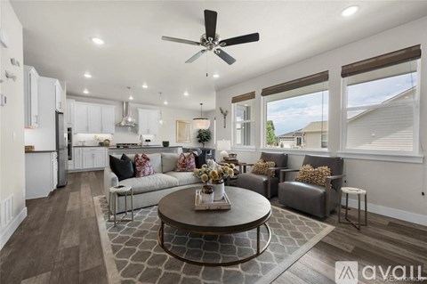 A living room with a grey couch and a coffee table in the middle.