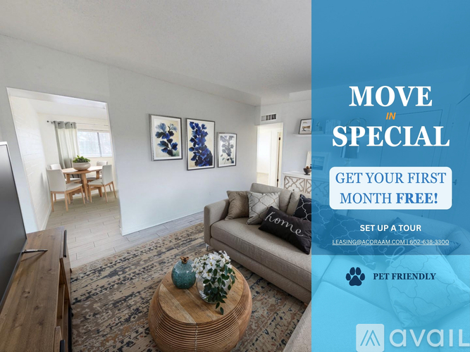 A living room with a couch, coffee table, and pictures on the wall, with a sign offering a free first month of rent.