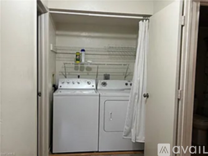 A small laundry room with a washer and dryer.