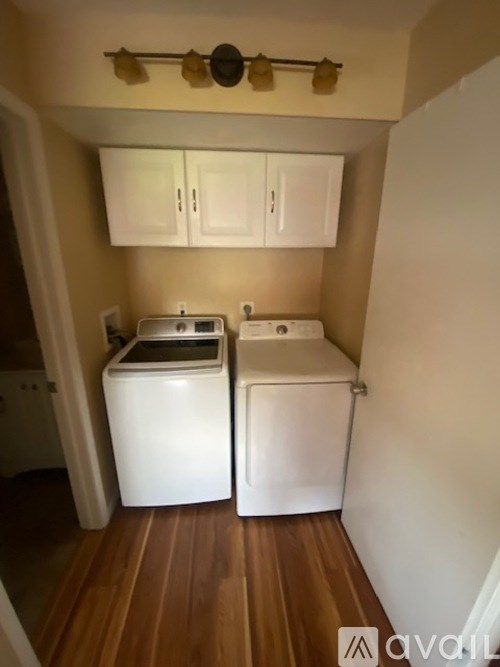 A small kitchen with a washing machine and a dryer.