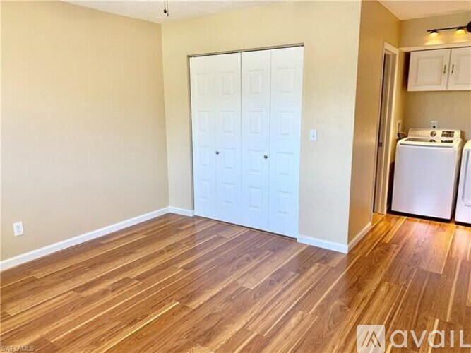 A room with a black table and a white door.