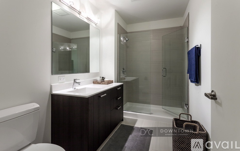 A bathroom with a toilet, sink, and shower.