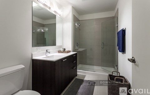 A bathroom with a toilet, sink, and shower.