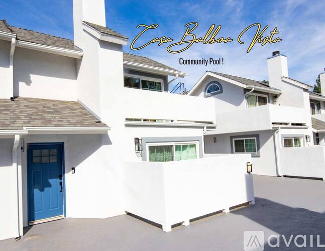A white building with a blue door and the words "Cove Ballina View Community Pool!" written on the top.