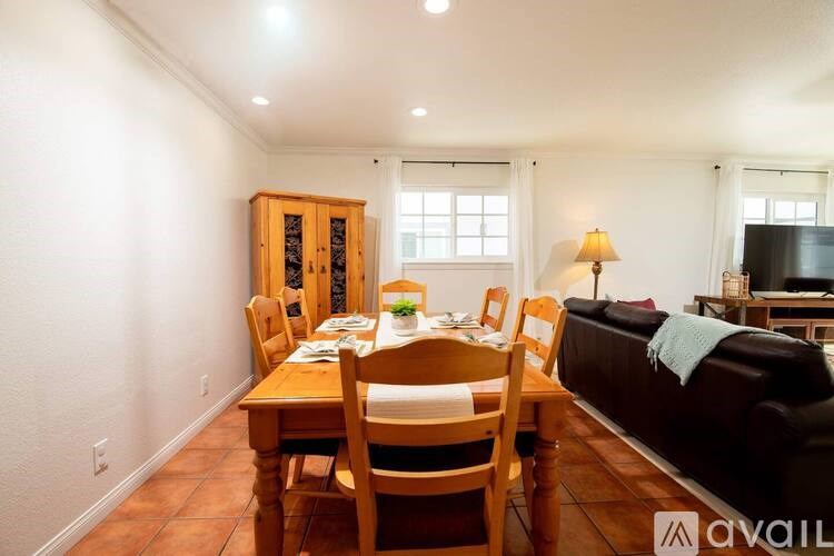 A dining room with a wooden table and chairs.