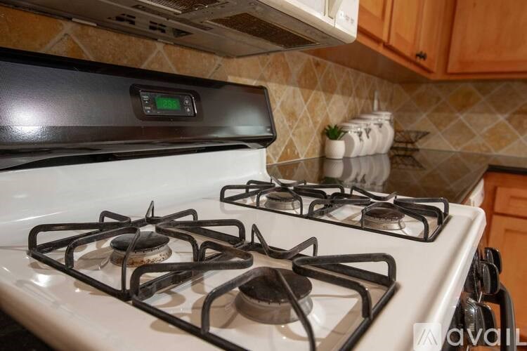 A white gas stove with a digital display on the stove top.